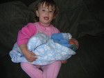 Rebecca holding her new brother
